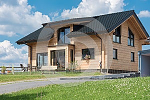 Beautiful prefabricated house with meadow under blue sky