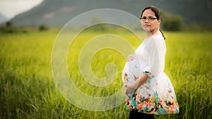 Beautiful Pregnant Asian Woman in Rice Field