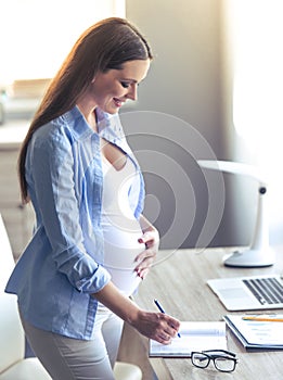 Beautiful pregnant business woman