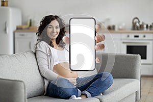 Beautiful Pregnant Female Holding Blank Smartphone With White Screen In Hand