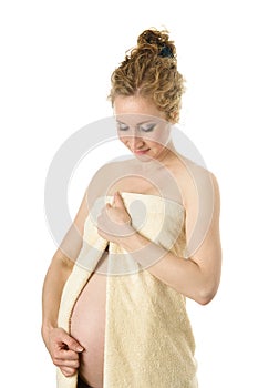 The beautiful pregnant girl in a towel