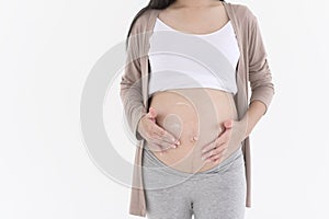 Beautiful pregnant woman applying moisturizing, stretch mark cream on belly, fertility infertility treatment, IVF, future