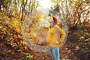 Beautiful pregnant woman in autumn.