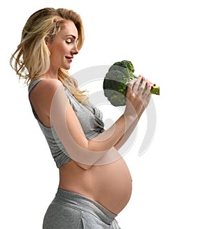 Beautiful pregnant woman big belly holding broccoli Pregnancy motherhood expectation healthy eating