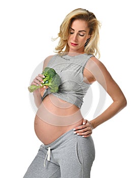 Beautiful pregnant woman big belly holding broccoli Pregnancy motherhood expectation healthy eating