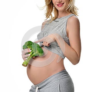 Beautiful pregnant woman big belly holding broccoli Pregnancy motherhood expectation healthy eating