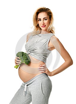 Beautiful pregnant woman big belly holding broccoli Pregnancy motherhood expectation healthy eating