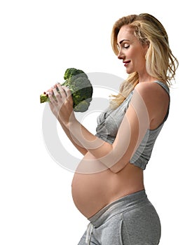 Beautiful pregnant woman big belly holding broccoli Pregnancy motherhood expectation healthy eating