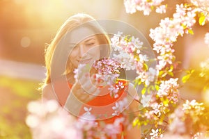 Beautiful pregnant woman in blooming garden