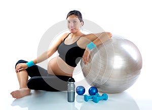 Beautiful pregnant woman at fitness gym relaxed