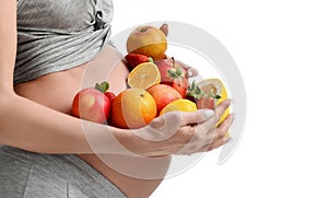 Beautiful pregnant woman with fresh fruits. Pregnancy motherhood expectation healthy eating and weight control concept