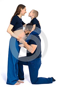 Beautiful pregnant woman with her family on white background