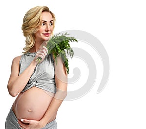 Beautiful pregnant woman hold organic dill for salad. Pregnancy motherhood expectation healthy eating