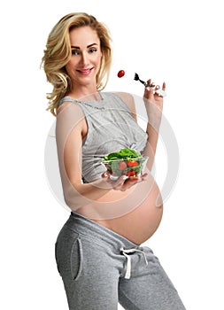 Beautiful pregnant woman hold organic salad. Pregnancy motherhood expectation healthy eating