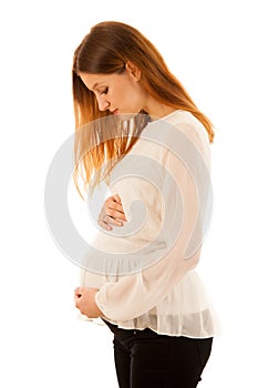 Beautiful pregnant woman holding belly isolated over white background