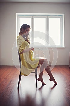 Beautiful pregnant woman at home portrait