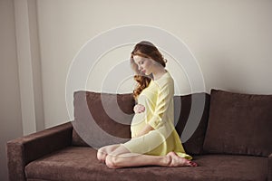 Beautiful pregnant woman at home portrait