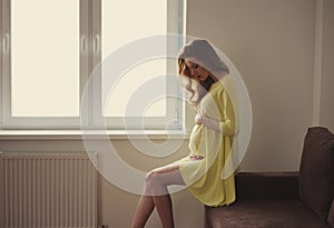 Beautiful pregnant woman at home portrait