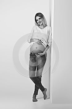 Beautiful pregnant woman in jeans