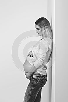 Beautiful pregnant woman in jeans