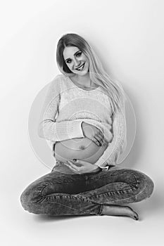 Beautiful pregnant woman in jeans