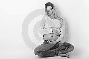 Beautiful pregnant woman in jeans