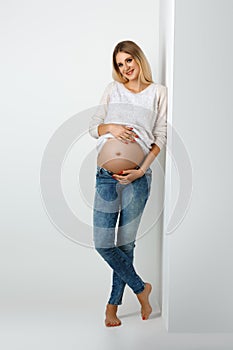 Beautiful pregnant woman in jeans