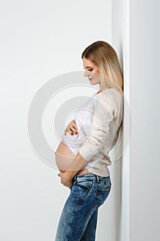 Beautiful pregnant woman in jeans