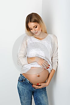 Beautiful pregnant woman in jeans