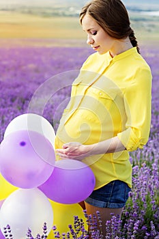 Beautiful pregnant woman in the lavender field