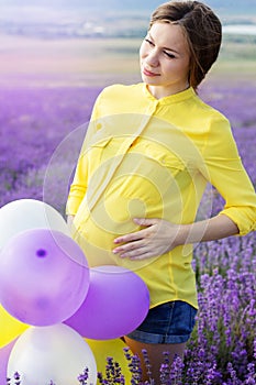 Beautiful pregnant woman in the lavender field