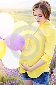 Beautiful pregnant woman in the lavender field