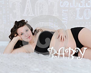 Beautiful pregnant woman laying down