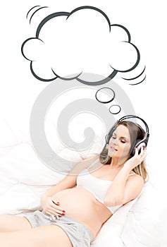 Beautiful pregnant woman listening to the music