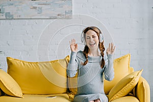 beautiful pregnant woman listening to music and dancing