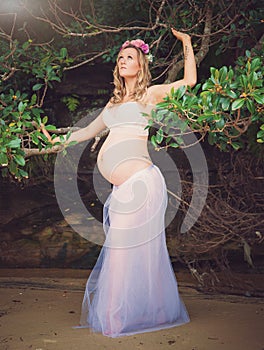 Beautiful pregnant woman outdoors in a park