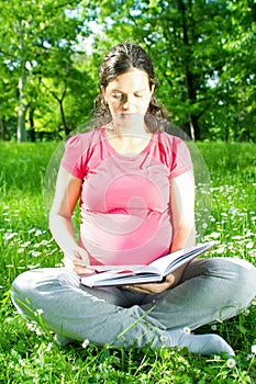 Beautiful pregnant woman in park