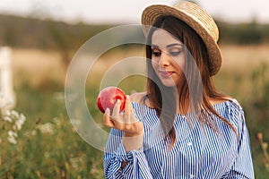 Beautiful pregnant woman show and eat red apple. Healthy food. Fresh fruits. Happy woman smile