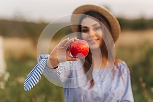 Beautiful pregnant woman show and eat red apple. Healthy food. Fresh fruits. Happy woman smile