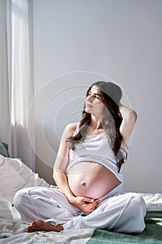 a beautiful pregnant woman smiles and looks away