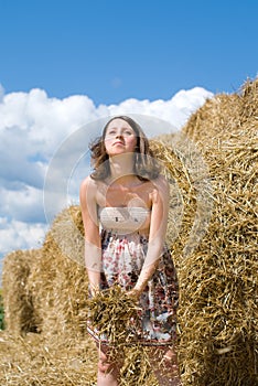 Beautiful Pregnant Woman takes Fun near Haystack