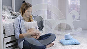 Beautiful pregnant woman talking to unborn child