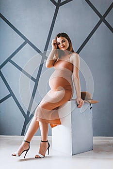Beautiful pregnant woman in their bedroom