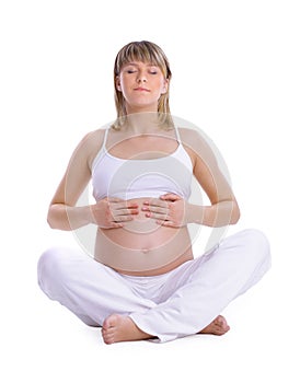 Beautiful pregnant woman touching her lovely belly