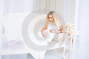 Beautiful pregnant woman in waiting for the baby. Pregnancy. Care, tenderness, maternity, childbirth.