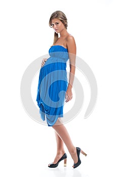Beautiful pregnant young girl in blue dress for pregnancy. Clothes for pregnancy