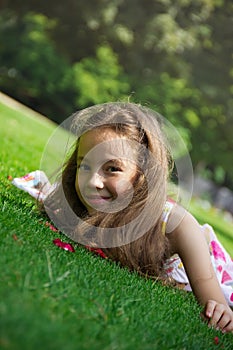 Beautiful preteen girl enjoying her time outside in park with sunset in background. Outdoors.