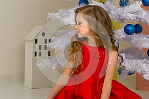 Beautiful Preteen Girl Posing in front of White Christmas Tree