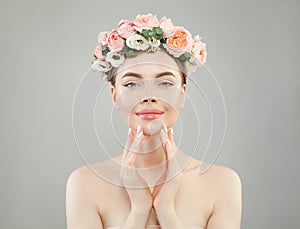 Beautiful pretty woman with clear healthy skin and roses flowers crown portrait