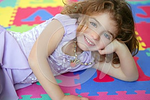 Beautiful princess little girl smiling lying floor